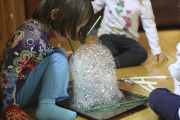 three children making bubble towers