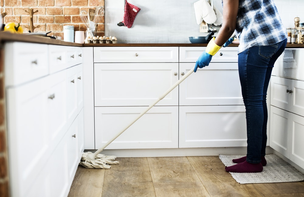 person mopping the floor