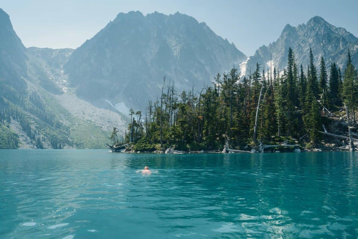lake in mountains with man floating