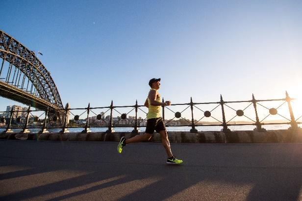 A person running on a road near a roller coaster

Description automatically generated with medium confidence