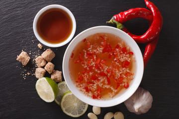 Vietnamese spicy sauce Nuoc Cham with the ingredients closeup. Horizontal top view