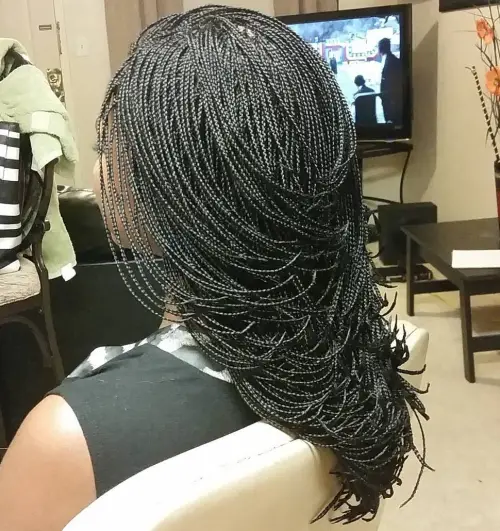 back view of a lady wearing layered micro braids