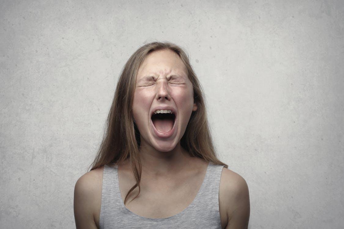 A woman expressing her emotions by screaming