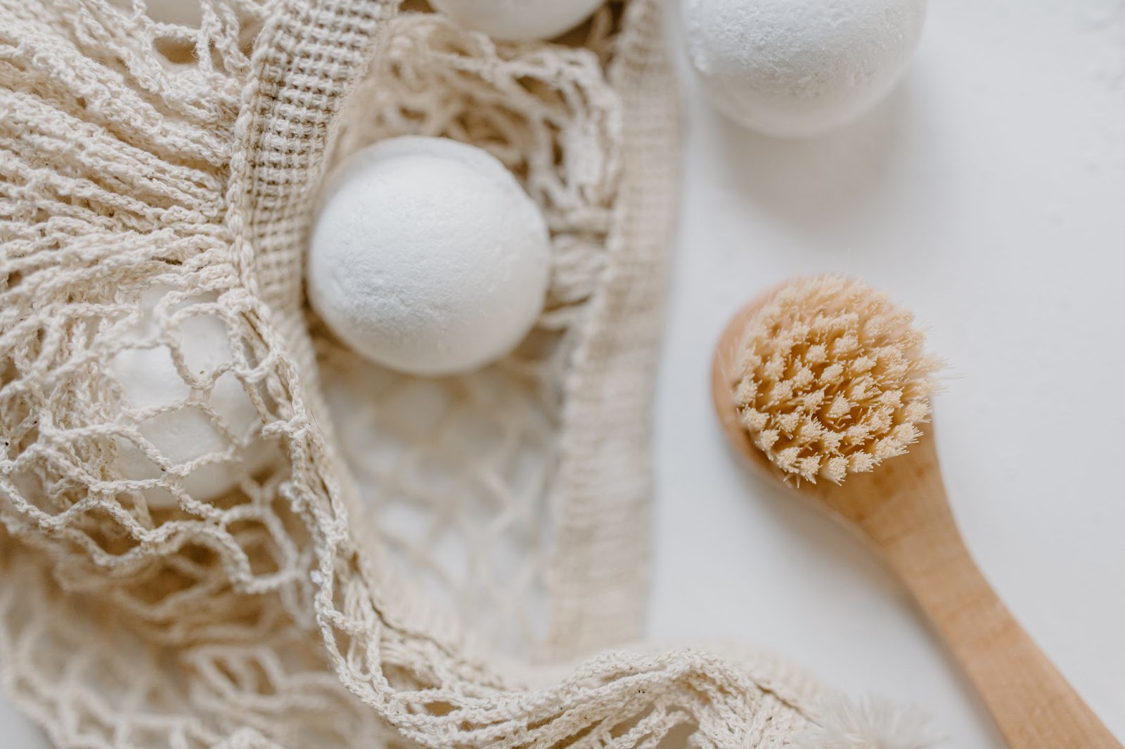 Close up of a bath bomb and a loofa. 'Self care' is one of the most popular beauty & jewelry keywords on Etsy.