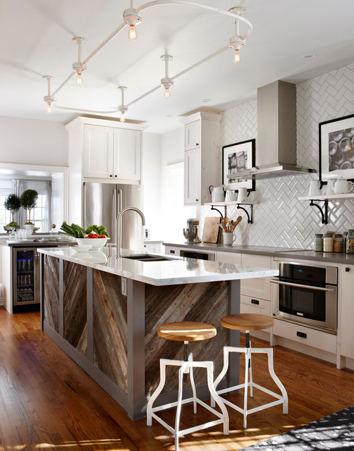 reclaimed wood island in a white kitchen with white backsplash and white marble countertop