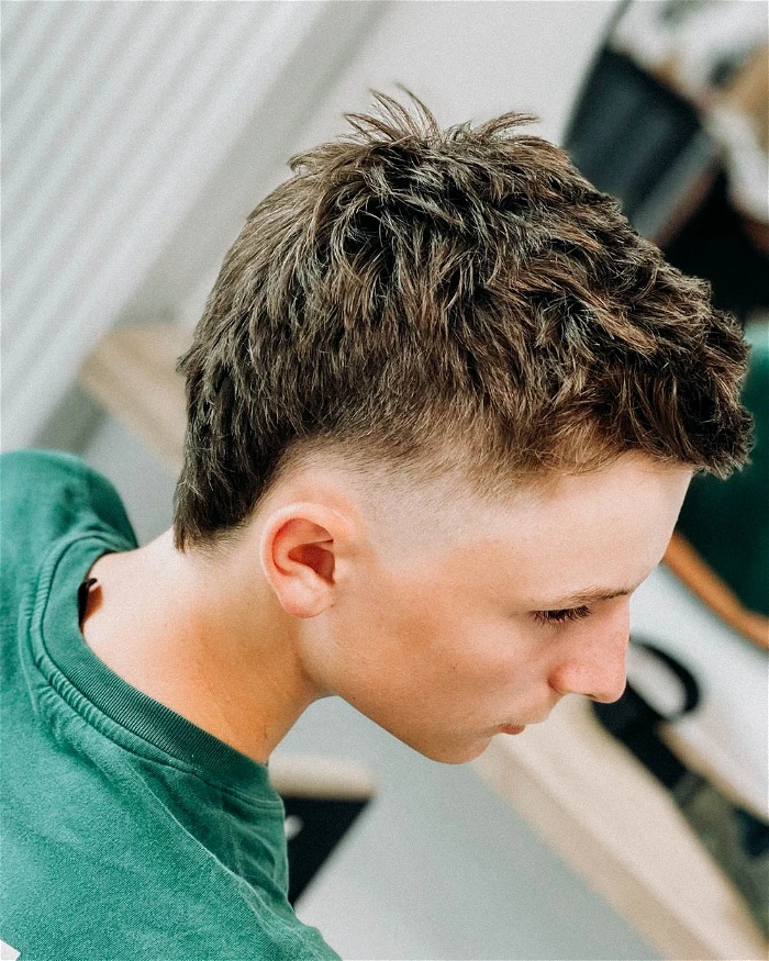 Side view of a man rocking the burst fade mullet straight hair