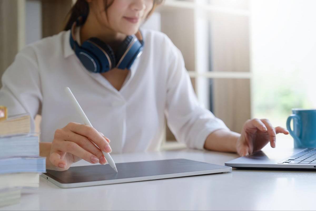 Woman sketches on tablet