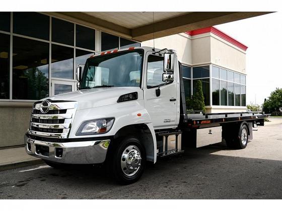 White Hino 258U Tow Truck sits sheltered near dealership in North York at Somerville Auto