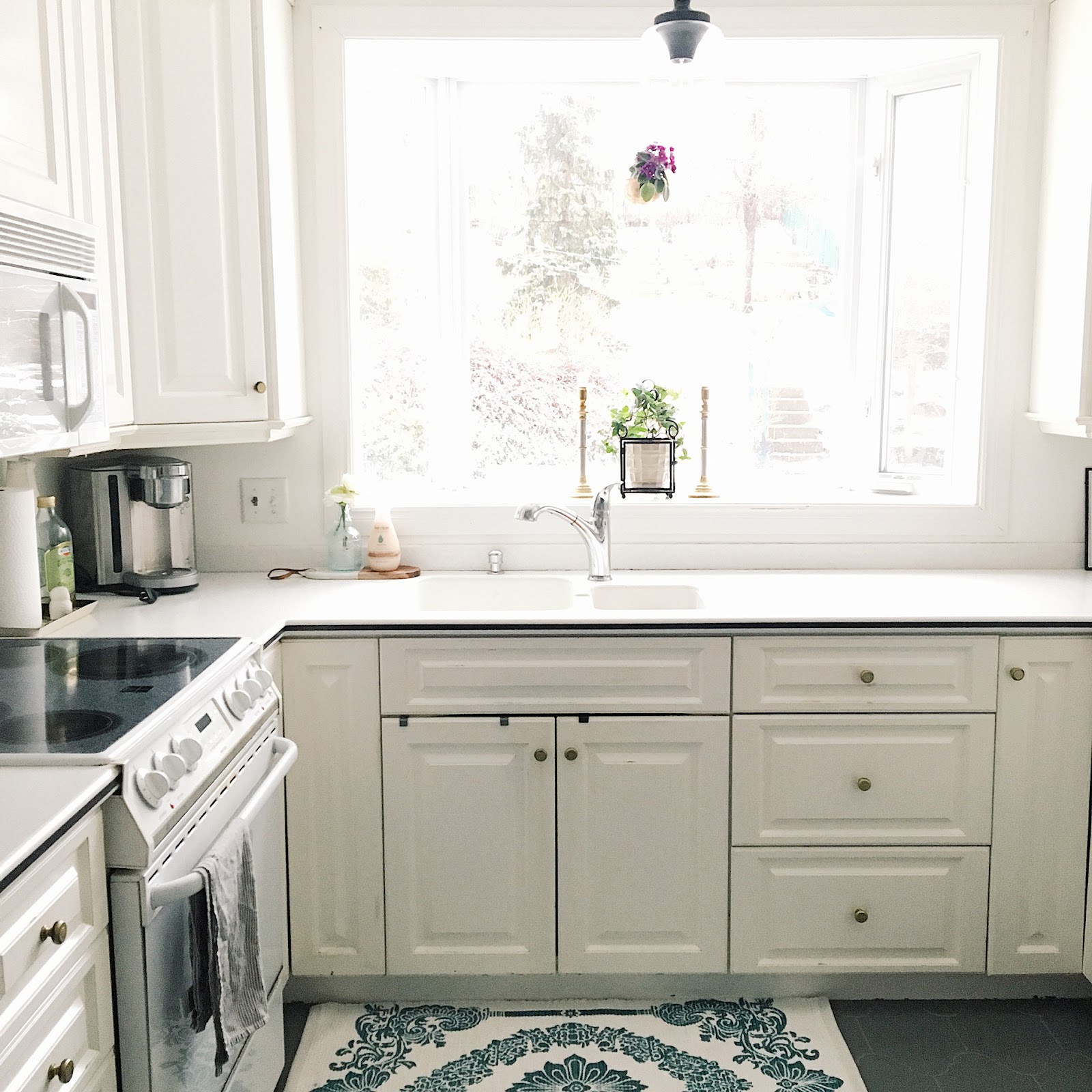 Bright white kitchen with a window over the sink