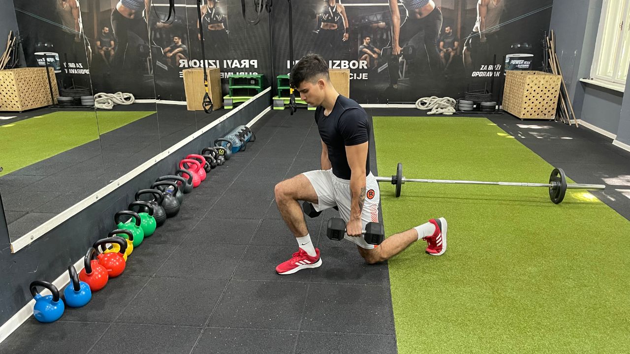 Vanja performs dumbbell lunges.
