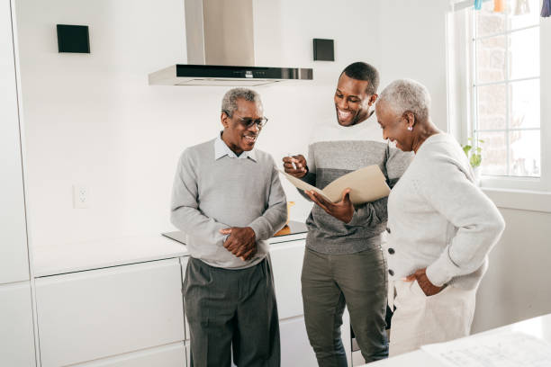 an adult man showing his parent the documents he signed for a perfect apartment he rented in Lagos
