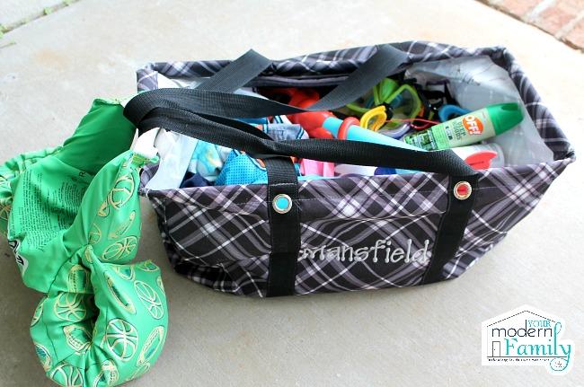 A duffel bag filled with children\'s items.