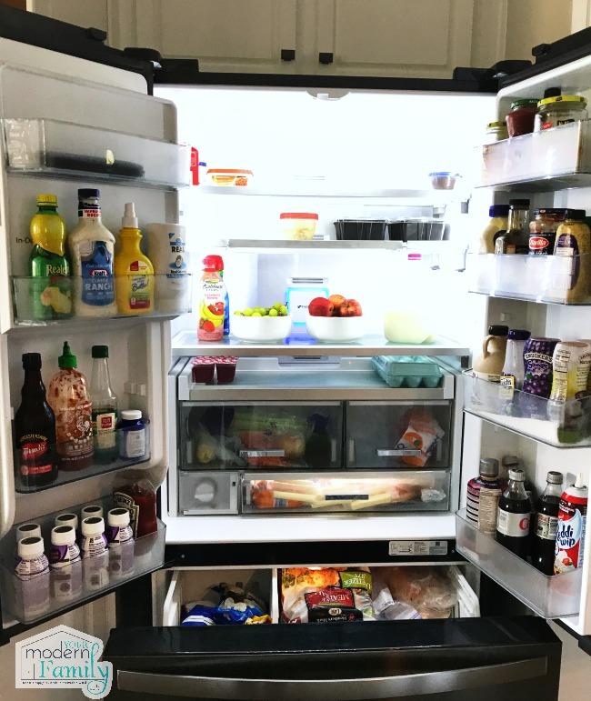 An open refrigerator filled with all the food organized on shelves.