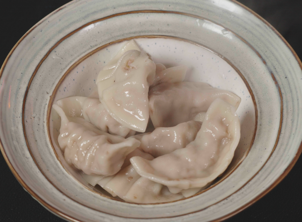 A picture containing plate, cup, dumpling, sliced

Description automatically generated
