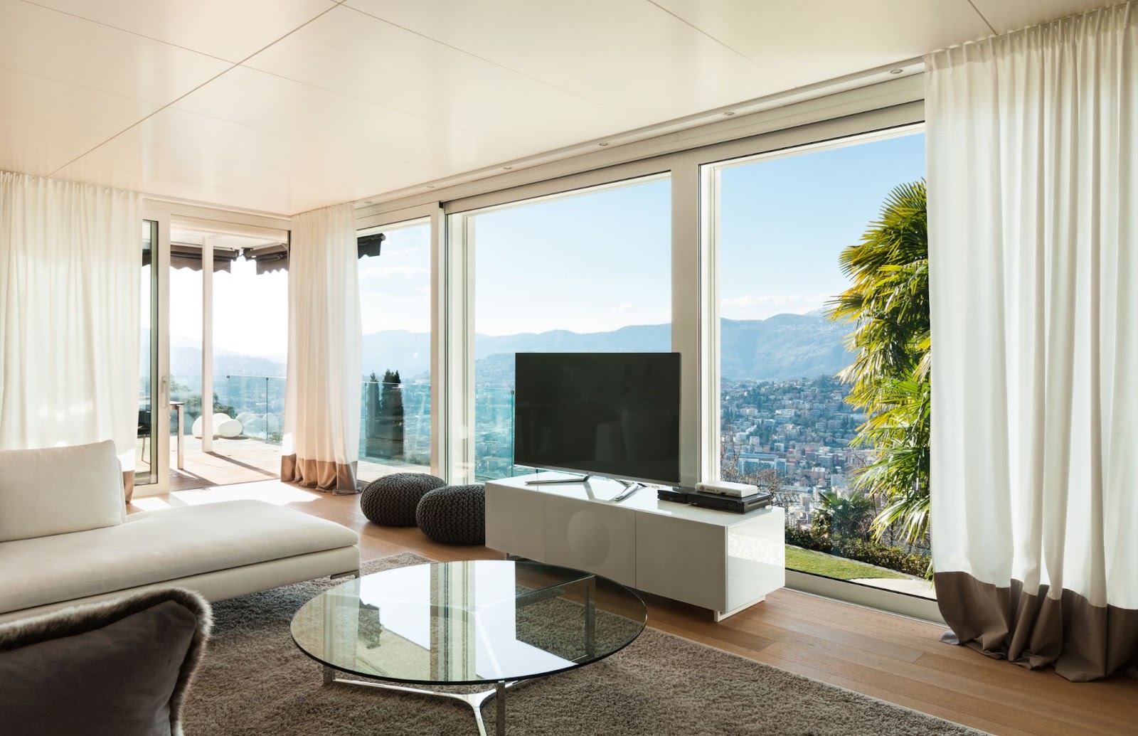 a modern home in the hills with large windows and a great view of the city