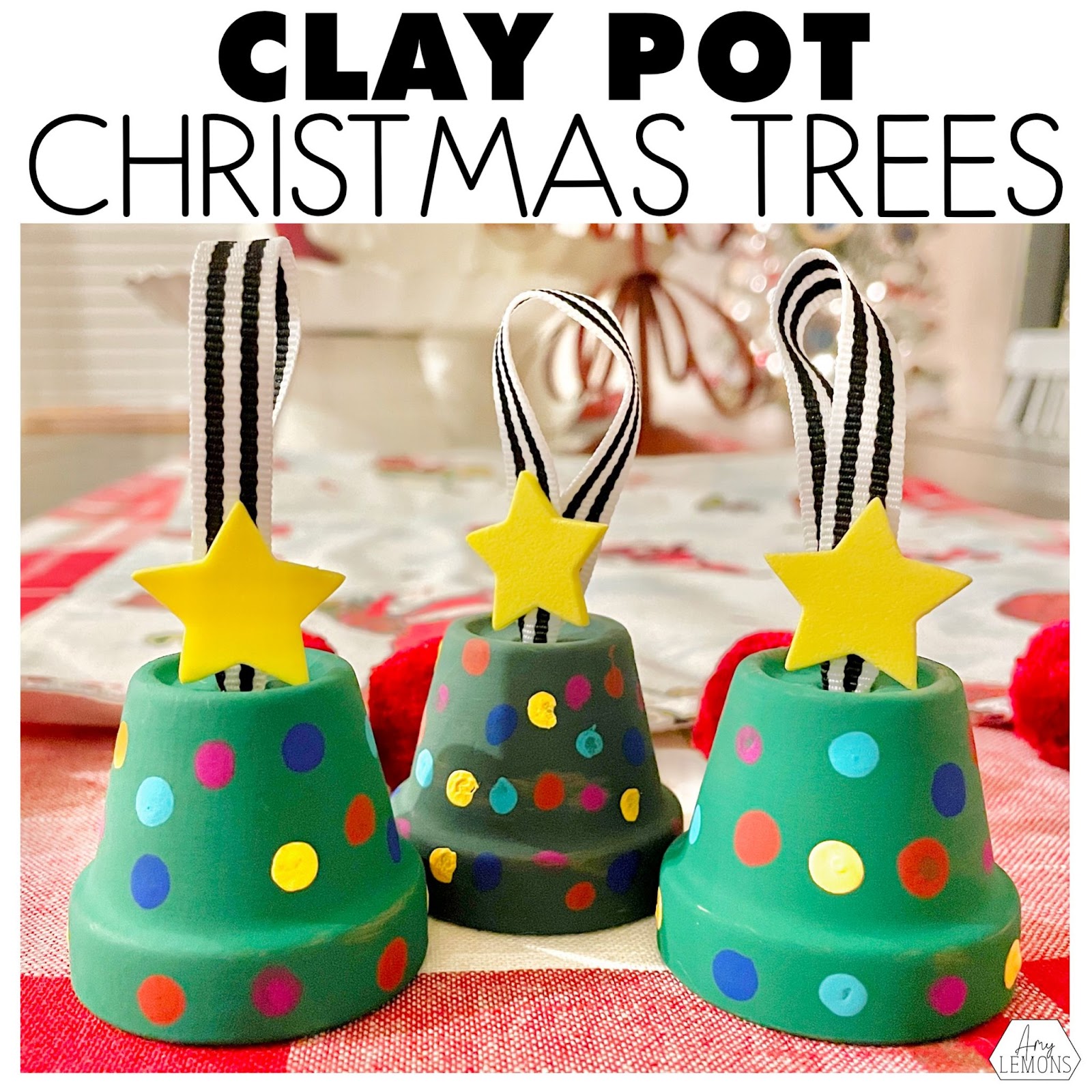 Christmas ornament made of a clay pot painted green with polka dot paint ornaments hung by a ribbon.
