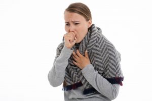 A woman is coughing 
because of allergy