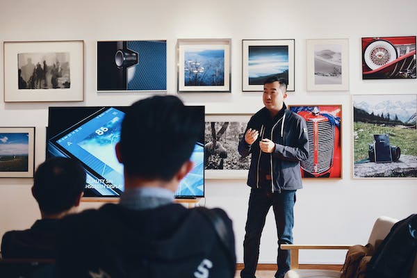 A man rendering speech to a group of people 