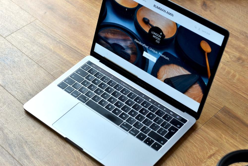 MacBook Pro turned-on on brown wooden surface