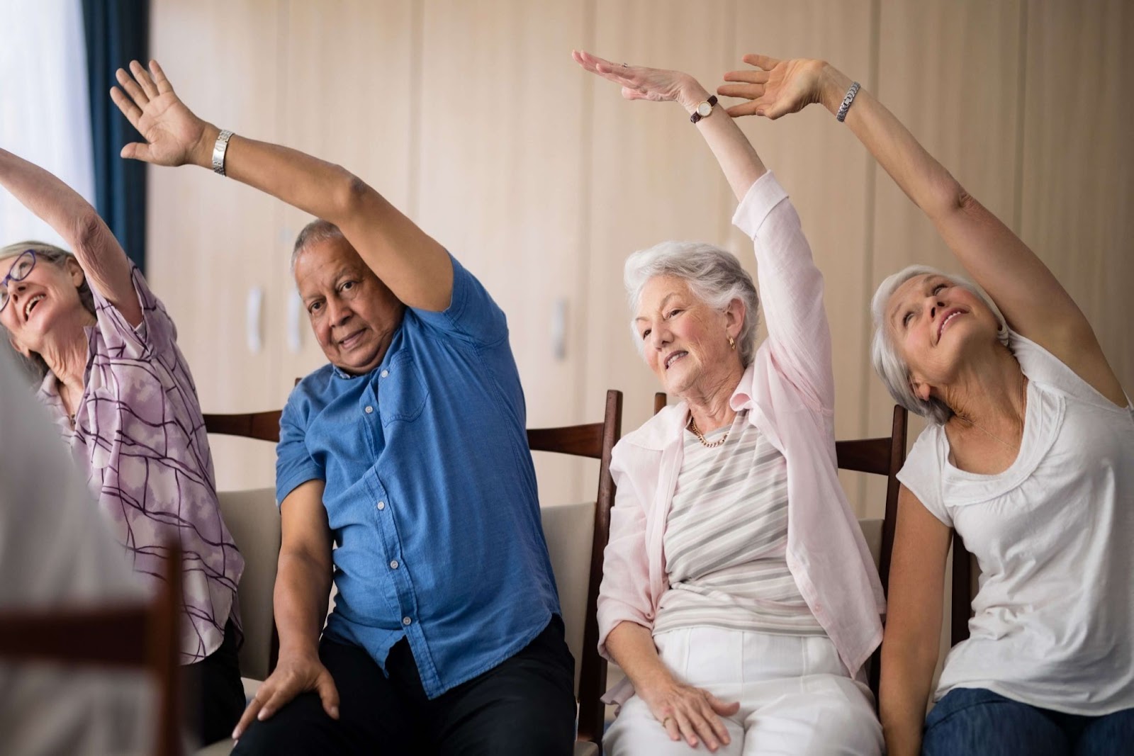 seniors in memory care do chair exercises
