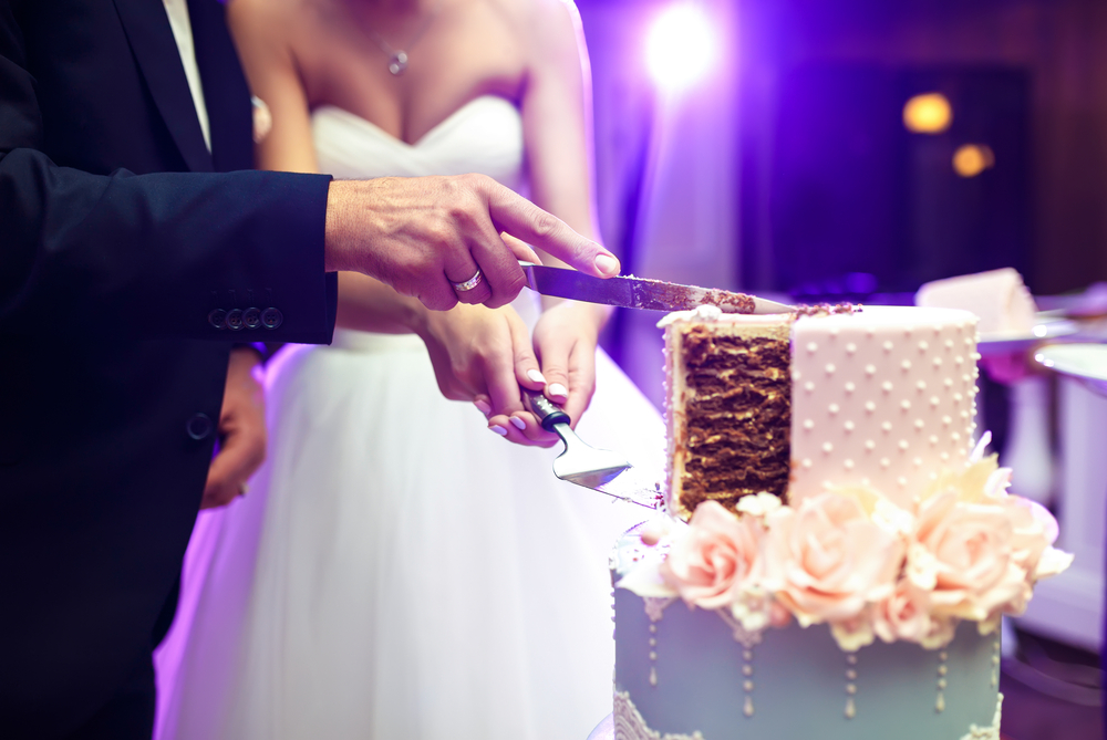 A bride and groom cutting the cake