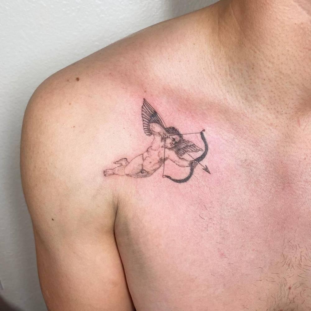 Fine line cupid tattoo