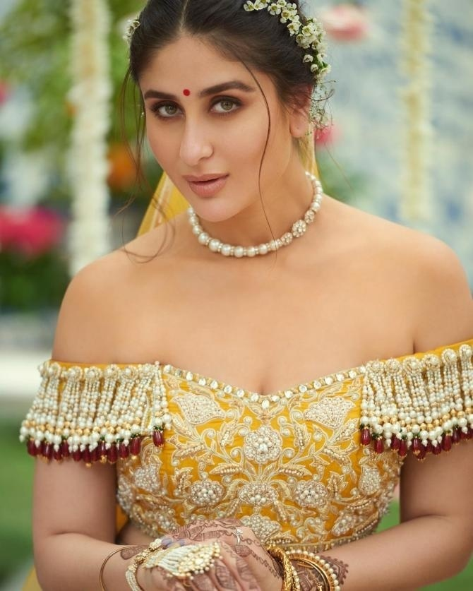 Kareena Kapoor in a light yellow off shoulder bridal blouse with silver tassel detailing.