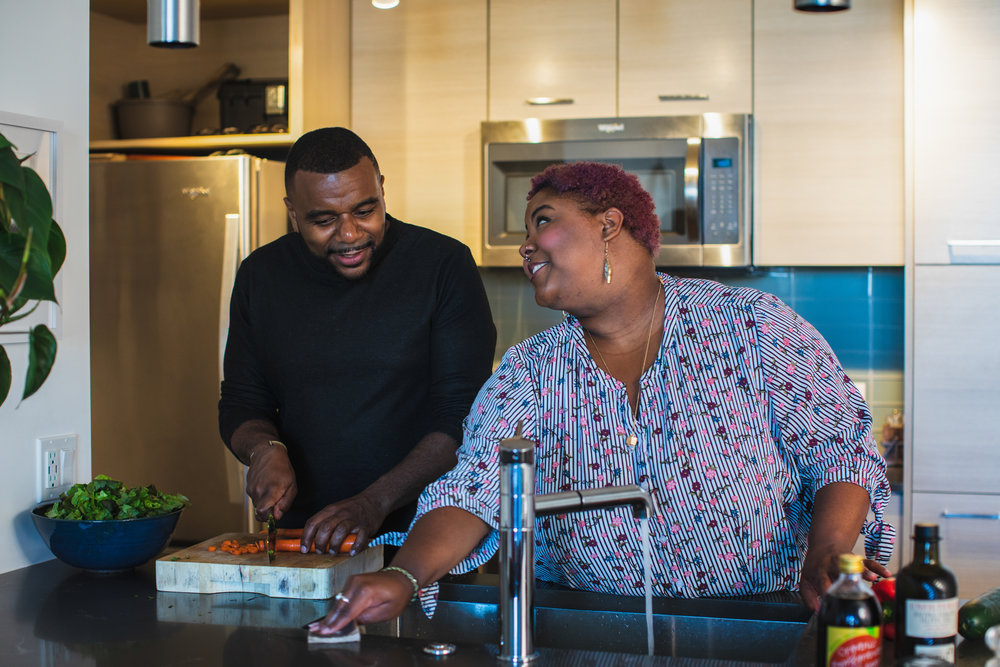 Hombre y mujer negros, una pareja, cocinando juntos en la cocina
