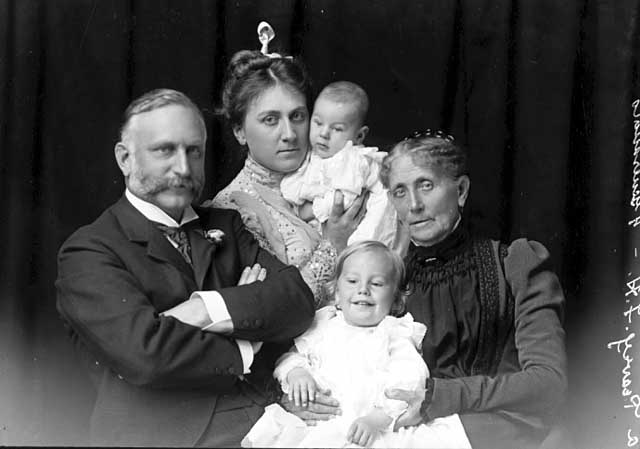 Lucia Peavey Heffelfinger, rear, holds her son, future Hazeltine National Golf Club founder Totton Peavey Heffelfinger, while her grandmother Mary holds Lucia's son Frank P. Also pictured is Lucia's father, Frank H. Peavey. The photo is dated 'about 1899,' which is the year Totton was born and the one year of existence of the six-hole practice golf course at Ferndale which was played by Lucia.  Photo courtesy of Justin Peavey.