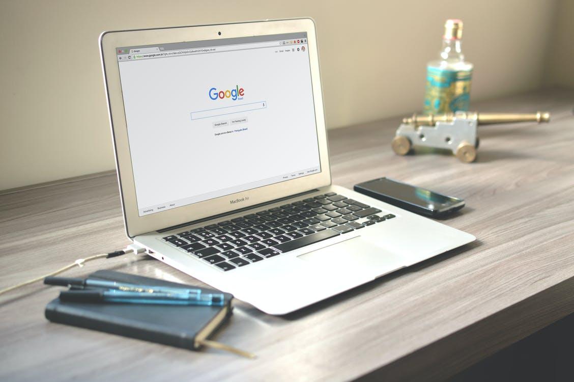 Free Macbook Air on Grey Wooden Table Stock Photo