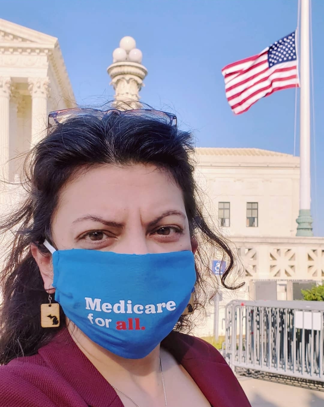 Rashida in a mask that says "Medicare for all"