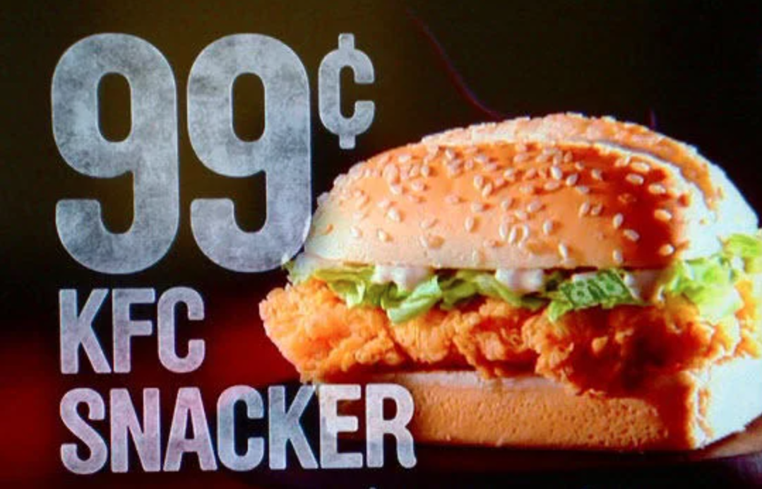 Picture of a KFC commercial portraying a hamburger with a text of "99 cents KFC Snacker".