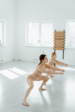 Free Woman and a Girl Doing Squats Stock Photo