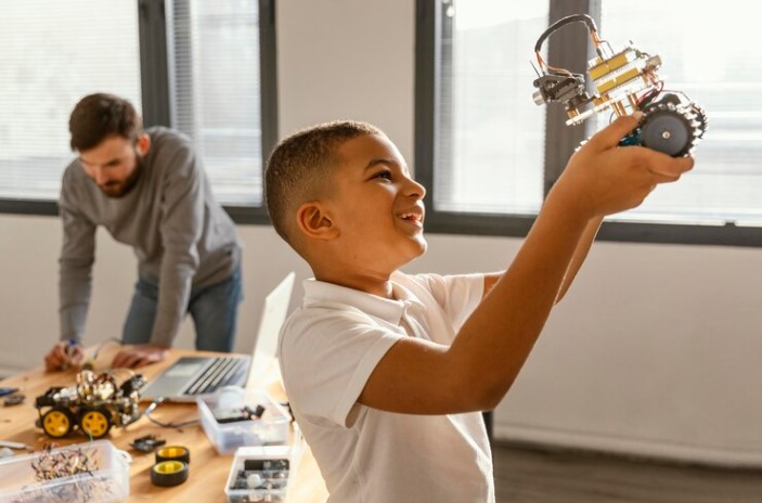 An adult and a kid developing and testing toys