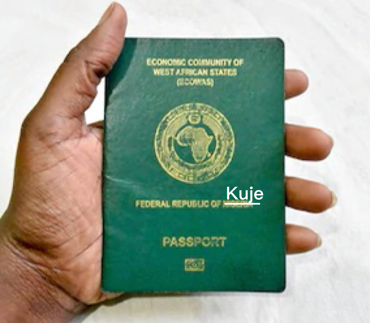 nigerian international passport with "Kuje" superimposed in a white underlined text over "Nigeria" on it