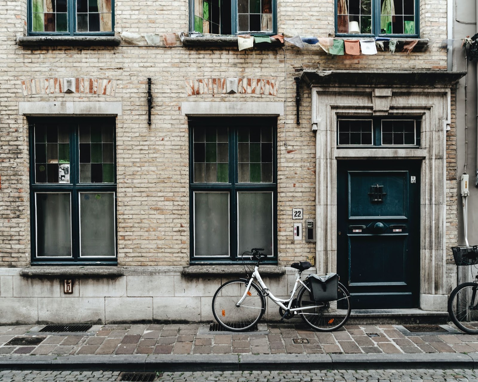 White bicycle on the street next to an old building in Belgium