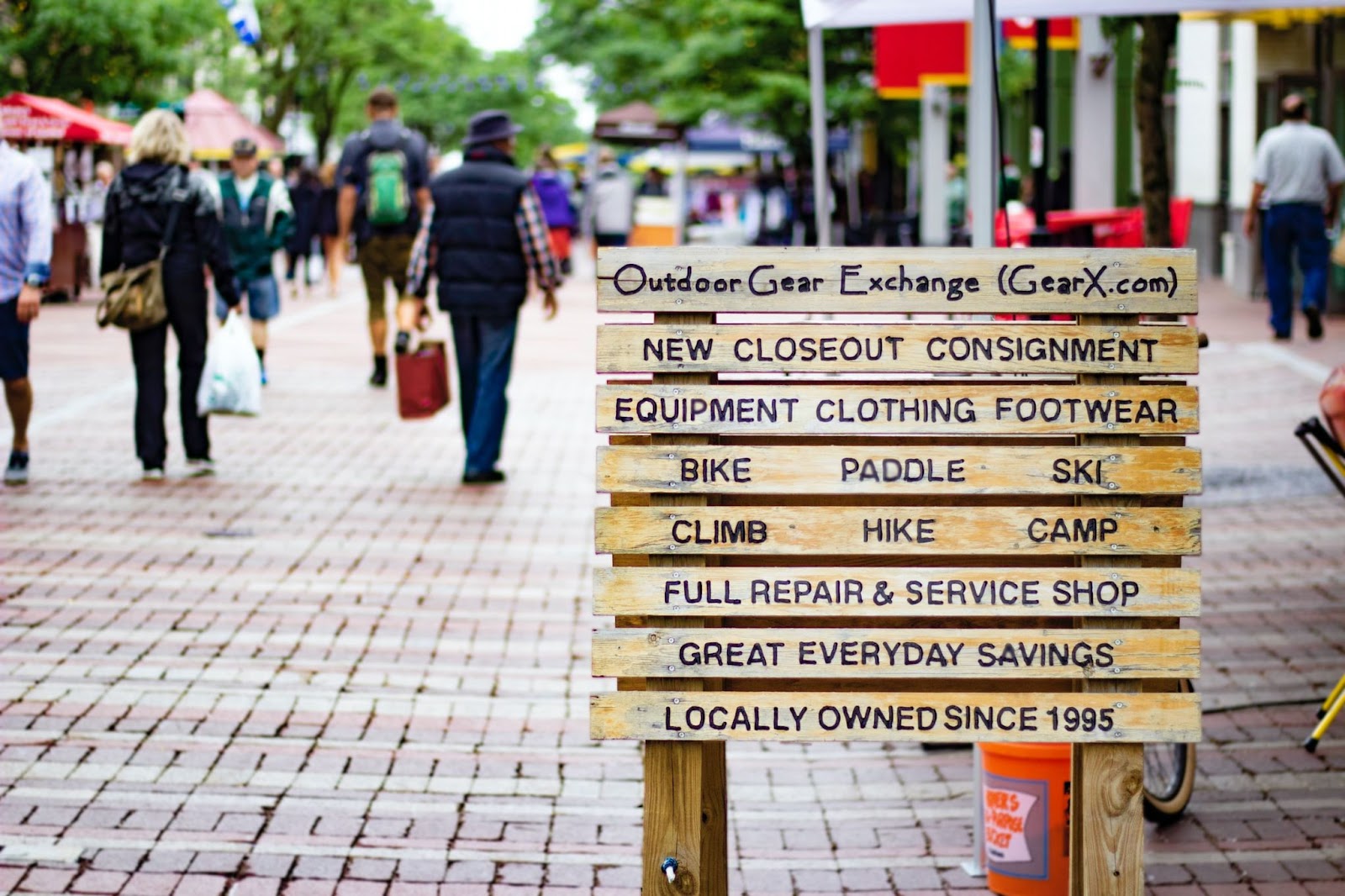 A wooden sign highlighting the Outdoor Gear Exchange shop