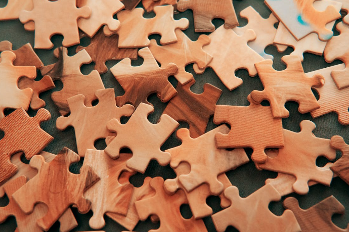 A picture containing jigsaw puzzle, indoor, stuffed, child

Description automatically generated
