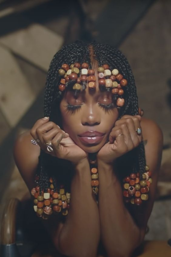 lady wearing African braids with beads