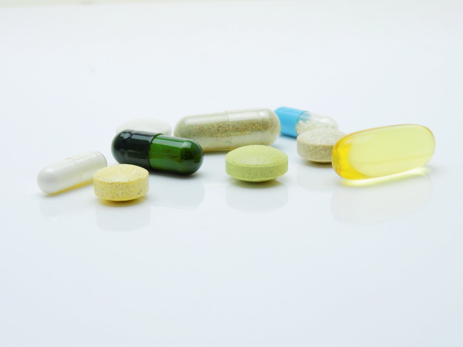 A variety of pills lay on a table.