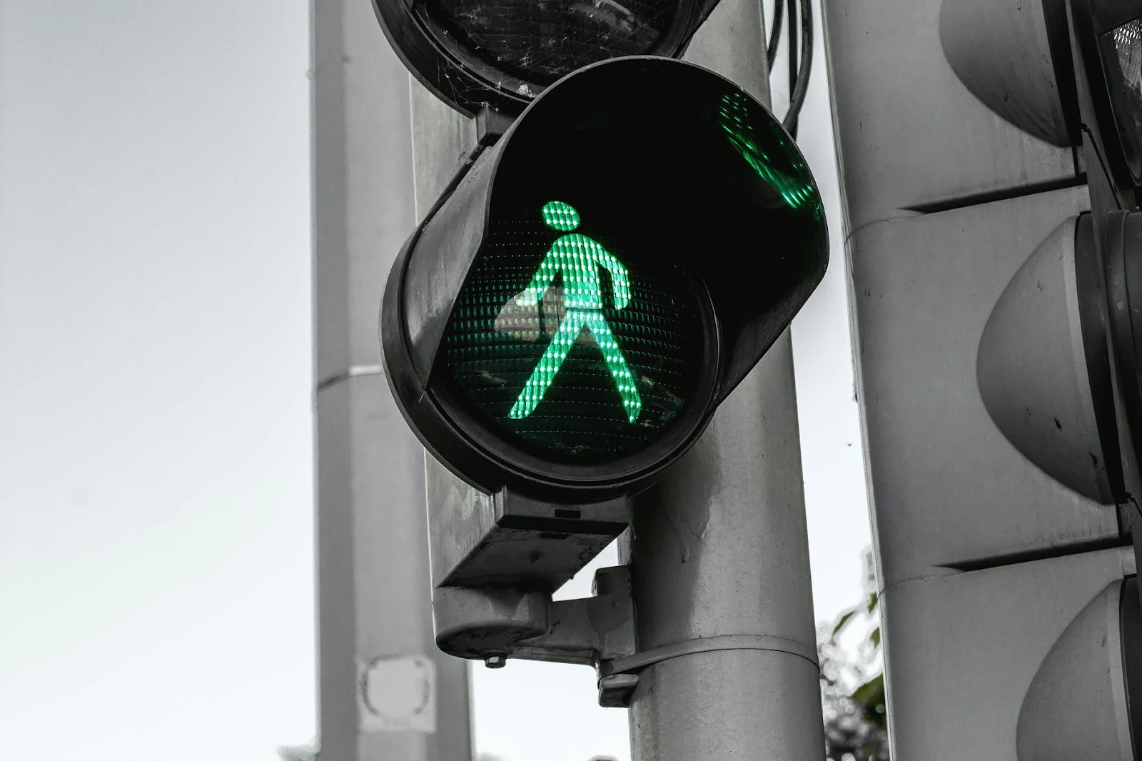 A closeup of green man on traffic light