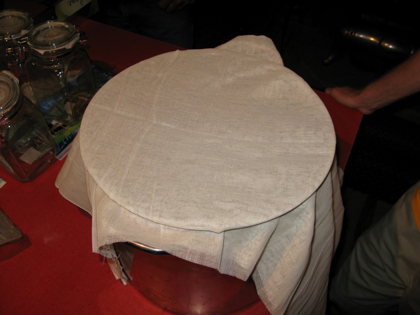 Cheesecloth over chokecherry wine fermentation vessel