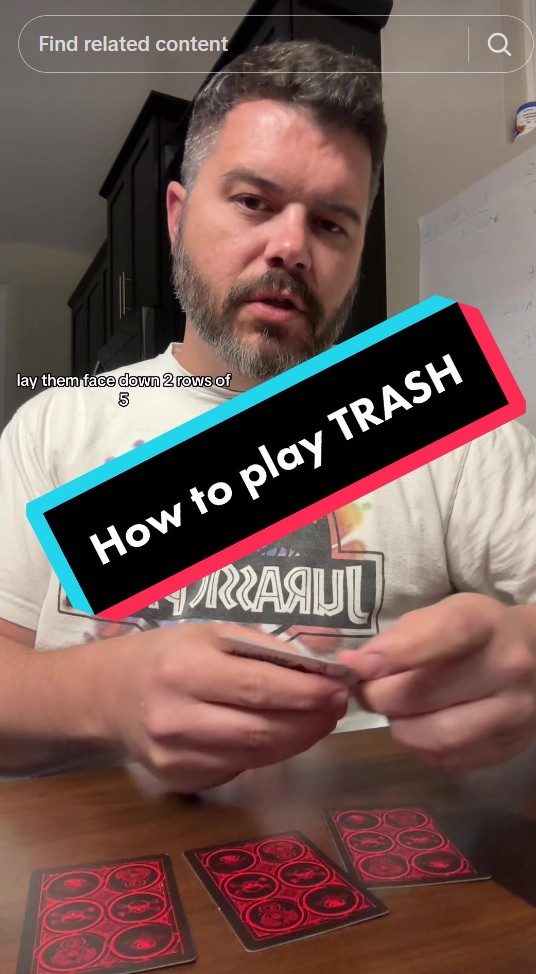 A screenshot of a social media post of a guy showing some cards and some texts saying "How to play TRASH"