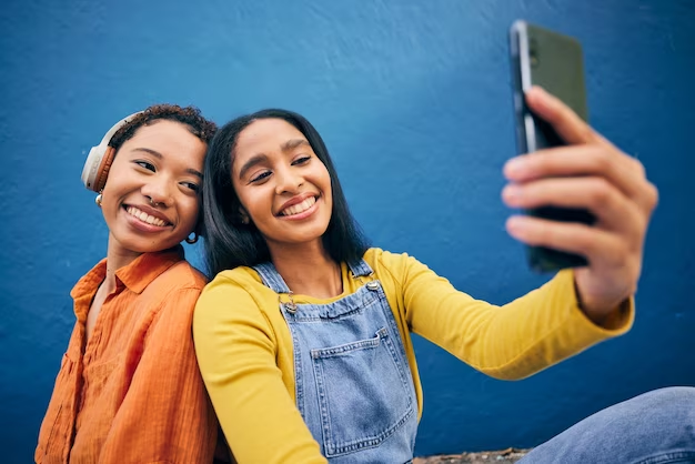 A Girl is Taking Selfie With Her Friend