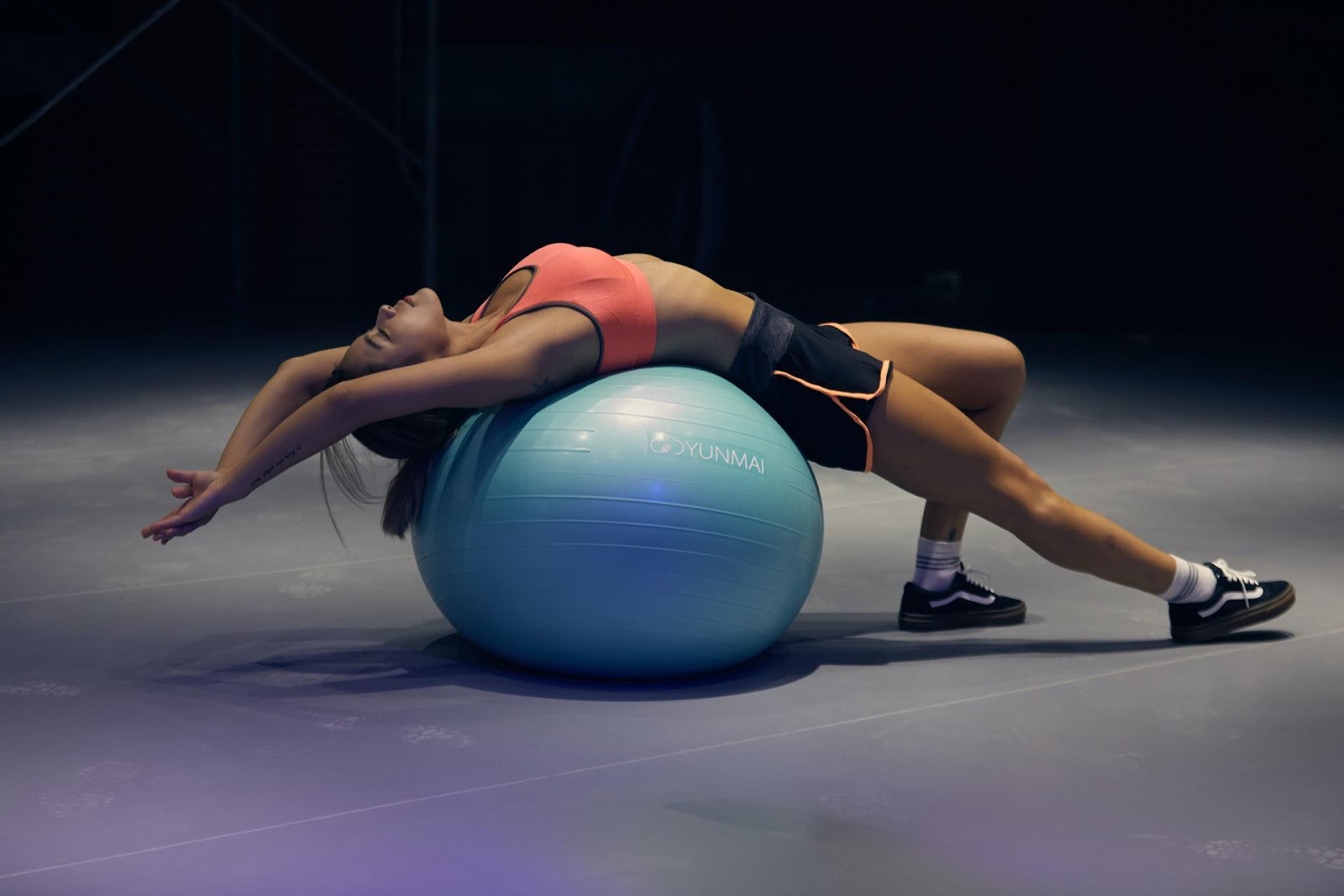 a woman lying back on the ball