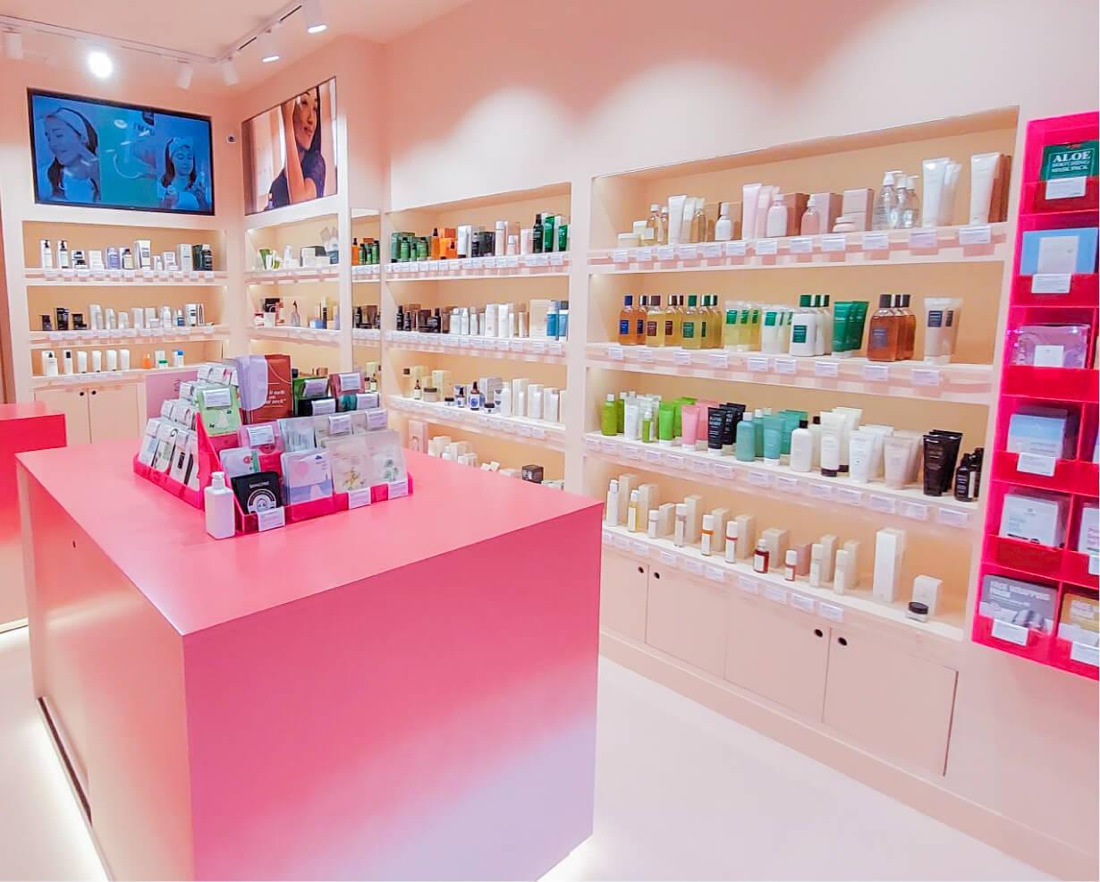 A pink counter with many bottles on it

Description automatically generated