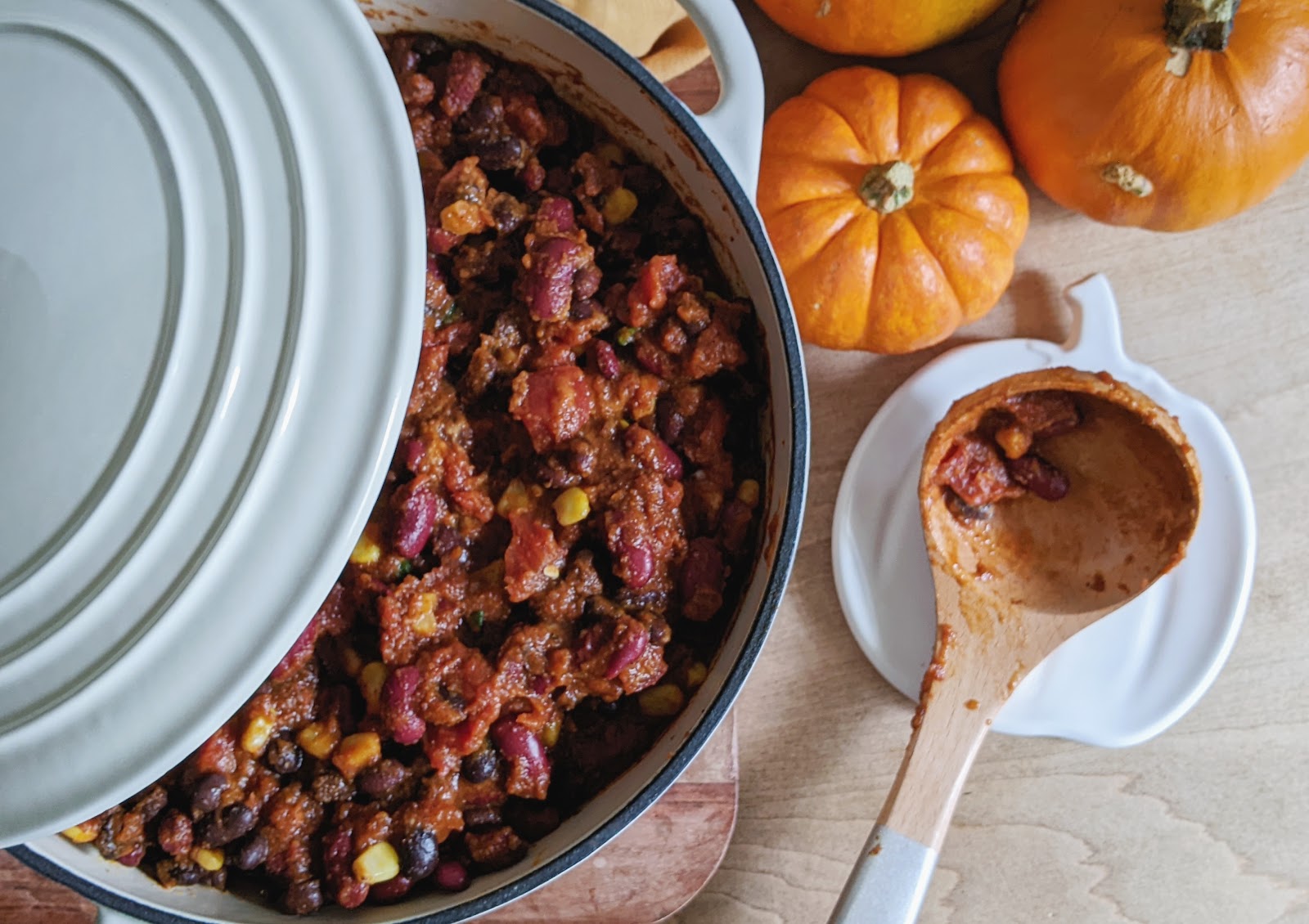 turkey chili in a large pot with wooden spoon