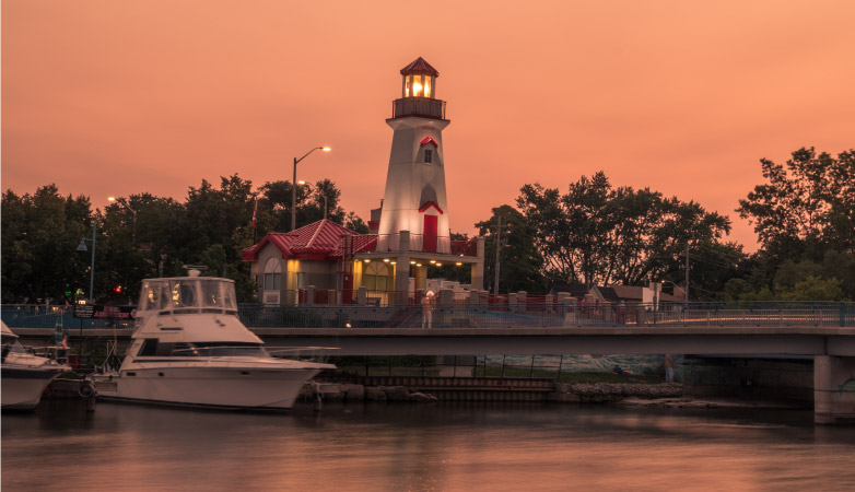 The sky is lit up in pink hues as the sun sets over Port Credit in Mississauga, ON, Canada.