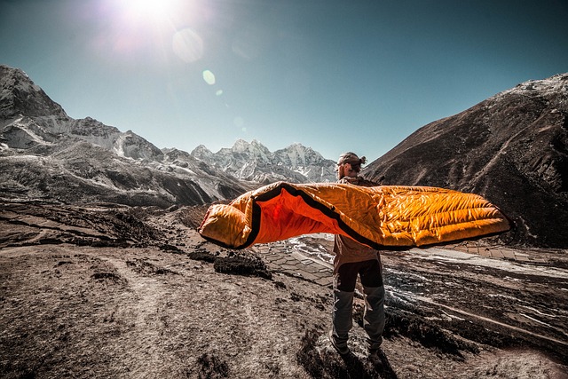 a man carrying one of the best camping cots and air mattresses