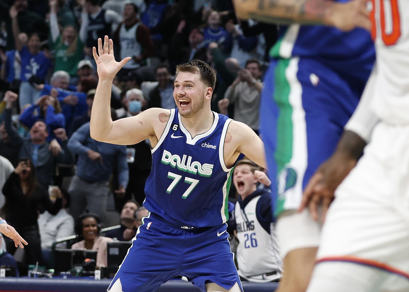 Luka Doncic waving on the basketball court.